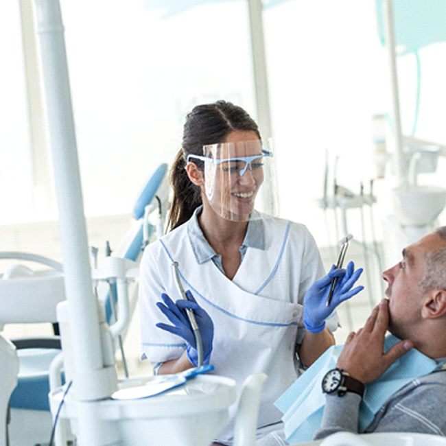 Dentist explaining how New You Dentures in Los Angeles work.