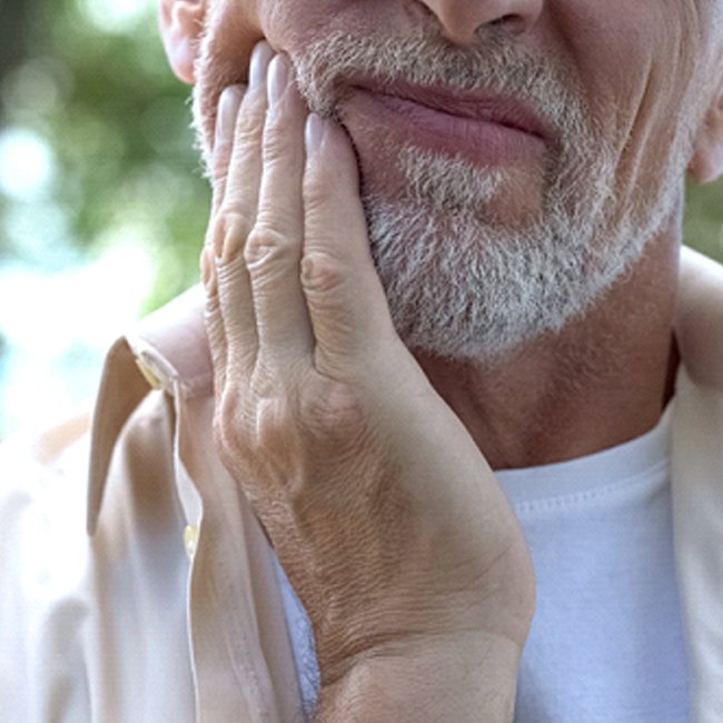 man experiencing dental implant failure and needing salvage in Van Nuys