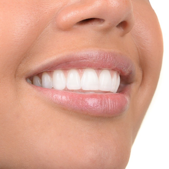 Patient smiling after gum grafting treatment