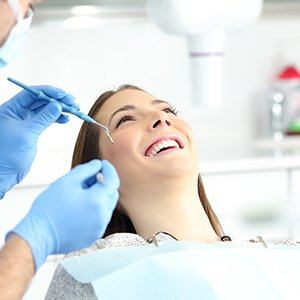 Patient smiling at her Los Angeles implant dentist during checkup