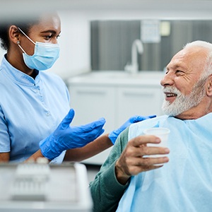 dentist explaining preliminary dental implant treatments