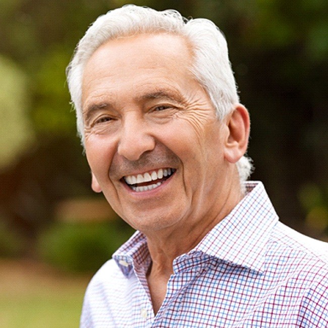 Senior man in patterned shirt with implant dentures in Los Angeles, CA