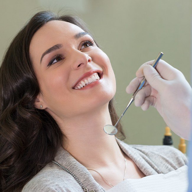 Woman smiling during preventive dentistry checkup