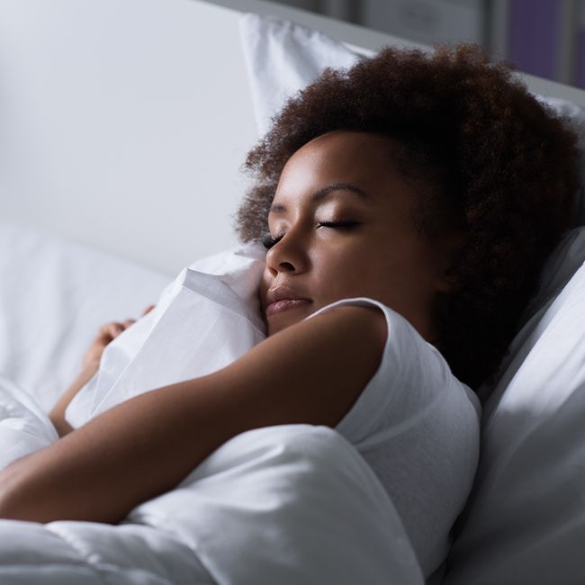 Woman sleeping soundly thanks to nightguard for teeth grinding