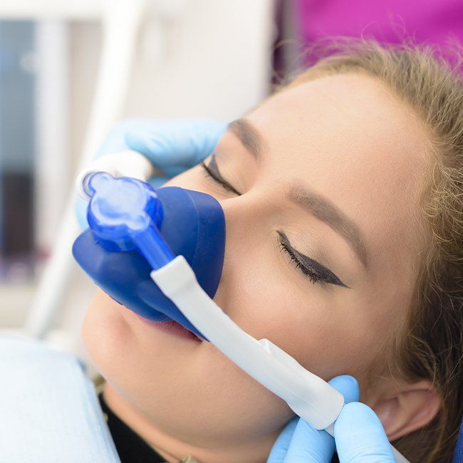 Woman with nitrous oxide dental sedation mask