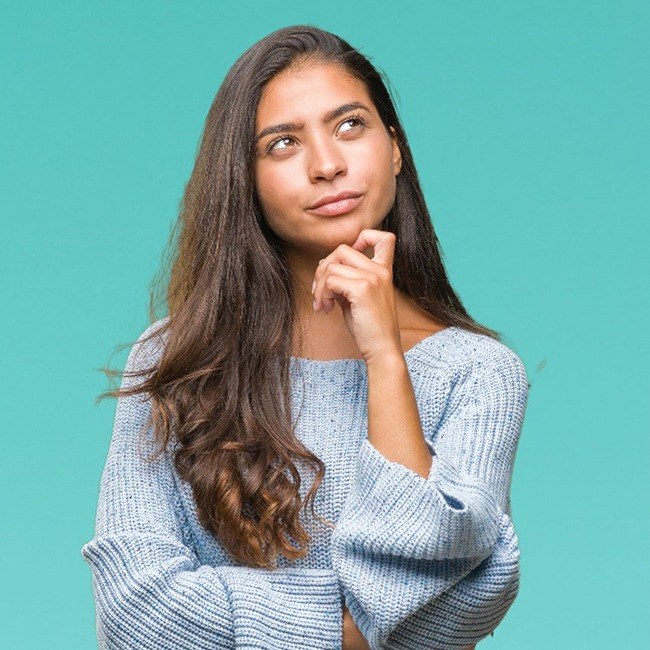 Woman wonders about sedation dentistry in LA on blue background