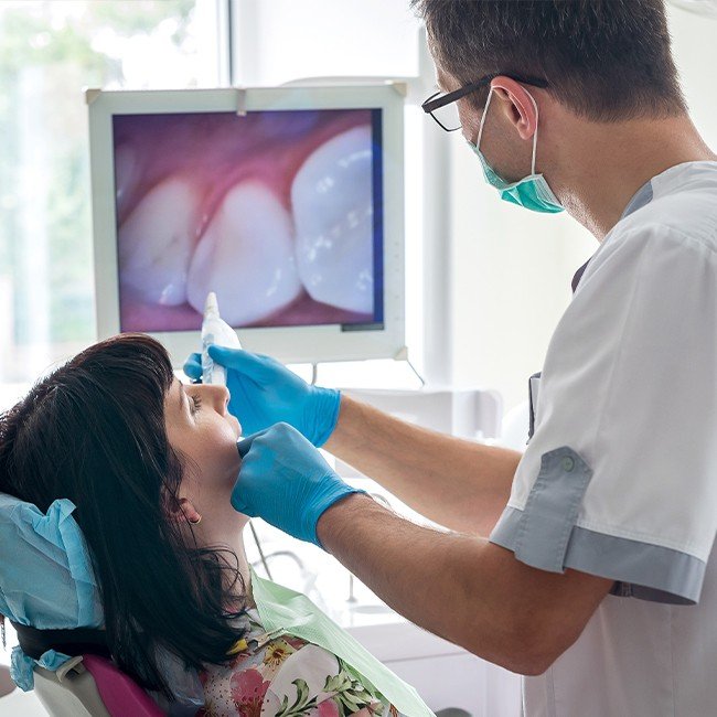 Dentist using intraoral camera to capture smile images