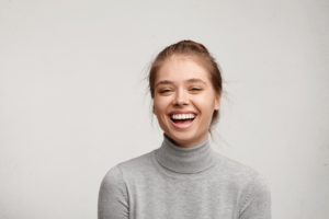 Portrait of smiling woman with dental crown in Van Nuys