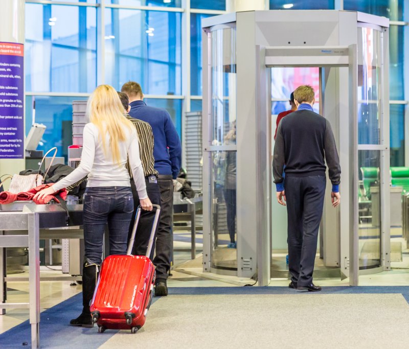 People going through airport metal detector